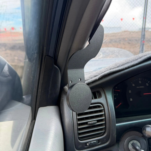 Car phone holder mounted inside a vehicle on the dashboard.